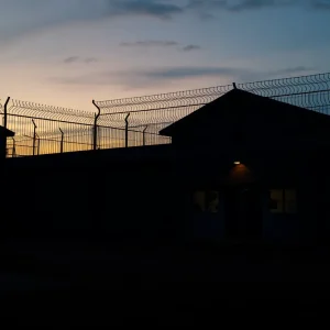 Somber prison setting symbolizing justice and human rights.