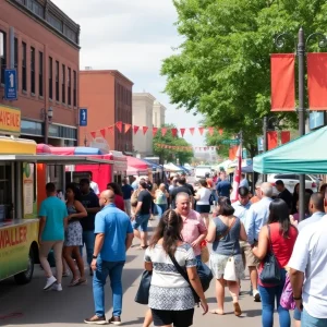 A lively street filled with people celebrating the reopening of Waller Avenue in Uptown Greenwood, featuring food trucks and local vendors.