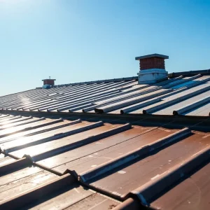 Different types of roof coatings applied on a roof under sunlight.
