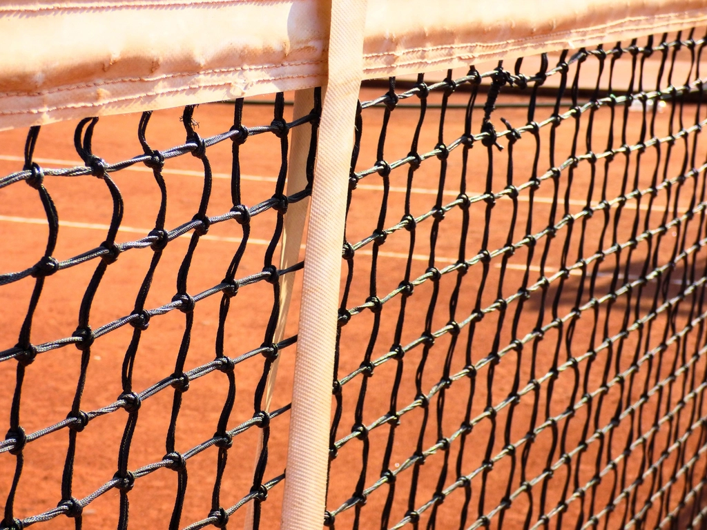 High school tennis match on an outdoor court
