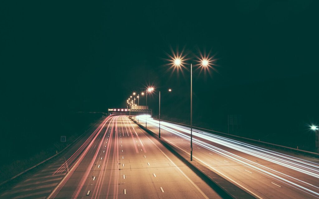 Light trails from cars on a highway at night